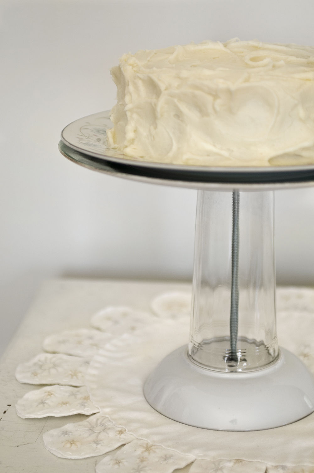 White cake on a homemade cake stand
