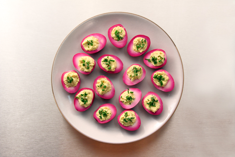 PINK DEVILED EGGS ON OPAQUE WHITE HEATH DINNER PLATE