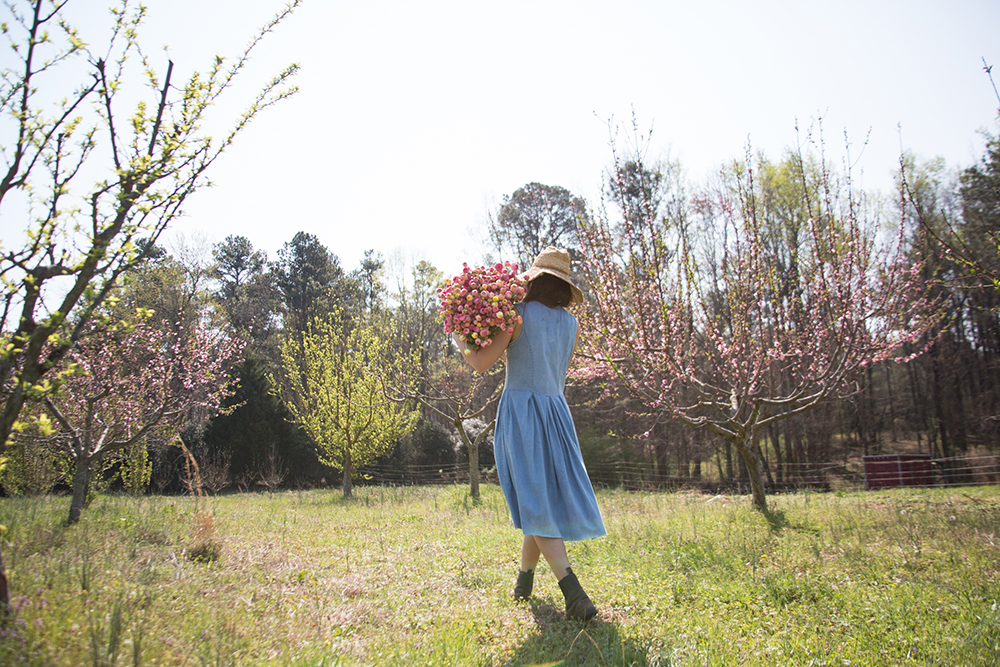 Springtime scene with organic cotton dress by Alabama Chanin and flowers from 3 porch farm by Rinne Allen