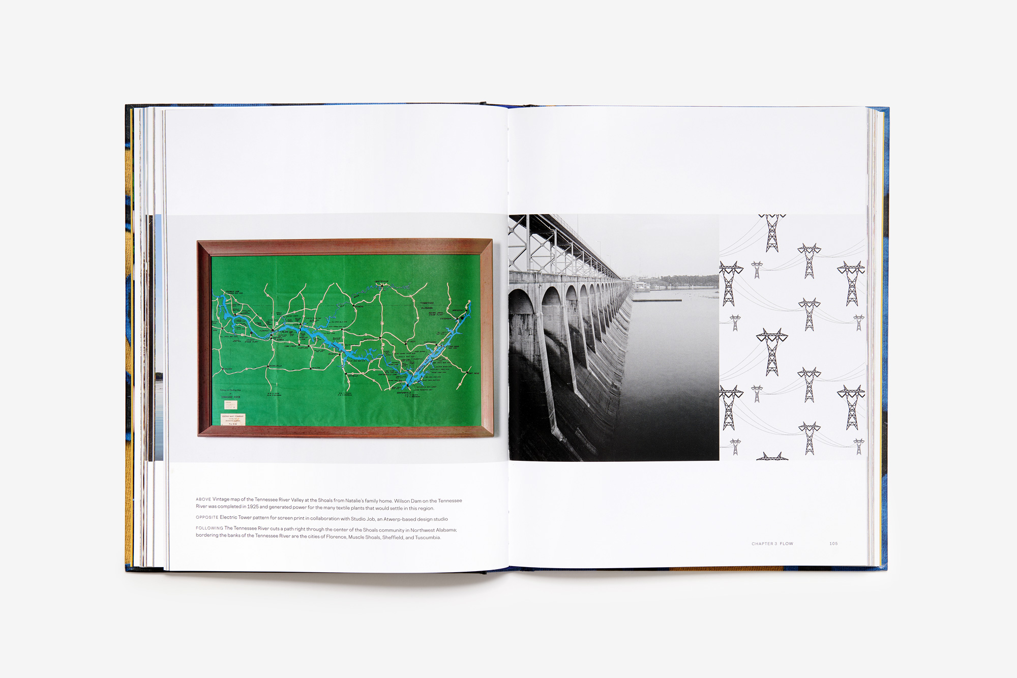 Open book with photographs of a map, a dam, and a design featuring electrical towers.